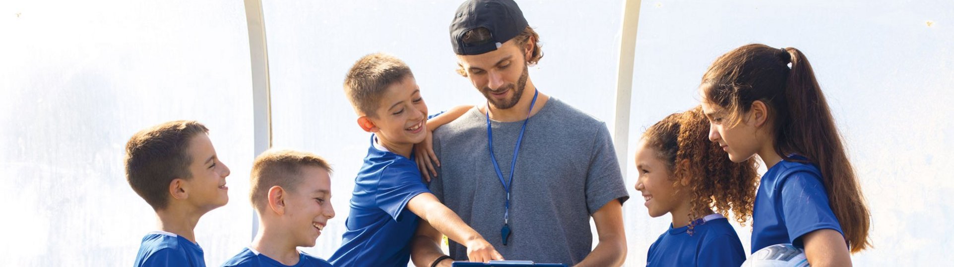 Trainer redet mit 5 jungen Spielerinnen